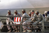 Dover AFB carry team moves up the transfer case of Pfc. Edwin C. Wood.