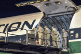 Chaplin Lt. Col. Douglas Arendsee, U.S. Air Force says a prayer as the Marine carry team bows their heads over the transfer case containing the remains of Marine L\Cpl Ross S. Carver of Rocky Point, NC.