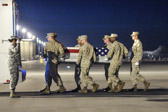 The Marine carry team carries the transfer case of Marine Lance Corporal Ross S. Carver of Rocky Point, NC to the transport vehicle.