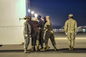 Carry team moves transfer case into the mortuary transfer vehicle