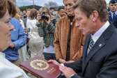 Gold Star Mother President Molly Morel presents Mr. Kenneth Fisher CEO of Fisher House Foundation with a book about the American Gold Star Mothers 1928 - 2010