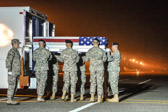 Army carry team moves the transfer case with the believed to be remains of Spc. Emilio J. Campo Jr., into mortuary transfer vehicle.