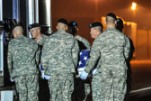 Army carry team moves the transfer case with the believed to be remains of Spc. Christopher B. Fishbeck, into mortuary transfer vehicle.