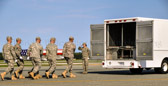 From the aircraft to the transfer vehicle the carry team(s) prepare to honor those who have given their lives in the service of our country.