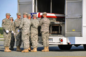 Army carry team moves the transfer case with the believed to be remains of Sgt. Devin J. Daniels into mortuary transfer vehicle.