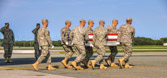The dignified transfer officer orders “Present, Arms” (slow movement salute).