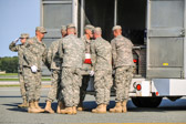Army carry team moves the transfer case with the believed to be remains of Pfc. Brandon S. Mullins into mortuary transfer vehicle.