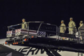 A dignified transfer is the process by which, upon the return from the theater of operations to the United States, the remains of fallen military members are transferred from the aircraft to a waiting vehicle and then to the port mortuary. The dignified transfer is not a ceremony; rather, it is a solemn movement of the transfer case by a carry team of military personnel from the fallen member's respective service. A dignified transfer is conducted for every U.S. military member who dies in the theater of operation while in the service of their country. A senior ranking officer of the fallen member's service presides over each dignified transfer.