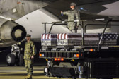 Transfer cases containing the remains of Marine Capt. Nathan R. McHone, left case, and Capt. Daniel B. Bartle, right case, sit on the K loader at Dover Air Force Base, DE. The Department of Defense stated that Captain McHone, of Crystal Lake, IL., and Captain Bartle, of Ferndale, WA, died Jan. 19, 2012 while supporting combat operations in Helmand province, Afghanistan.