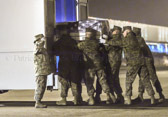 Marine carry team carries transfer case of Capt. Nathan R. McHone  to the mortuary transfer vehicle