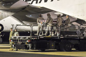 Transfer case of Master Sgt. Travis W. Riddick is moved into position on K-loader