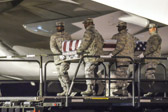 Transfer case of Cpl. Kevin J. Reinhard is moved into position on K-loader
