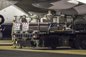 Transfer case of Cpl. Jesse W. Stites is moved into position on K-loader