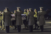 Dignified transfer officer orders “Present, Arms” (slow movement salute)