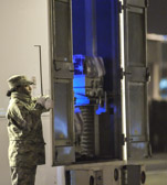 Transfer vehicle guide Senior Airman Brittney Bankes closes the doors  to transfer vehicle
