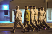 Dignified transfer officer and senior ranking officer follow (walking) behind the transfer vehicle guide, ending the dignified transfer