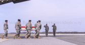Dignified transfer officer orders “Present, Arms” (slow movement salute)<br /><br />Air Force Col. John Devillier, Air Force Mortuary Affairs Operations, and Major Gen. John G. Rossi, Director, Army Quadrennial Defense Review Office of the Deputy Chief of Staff.