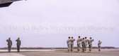 Dignified transfer officer orders final “Present, Arms” and “Order, Arms” (slow salute) as vehicle departs