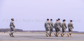 Carry team follows (by walking) transfer vehicle, with the transfer vehicle guide walking behind the carry team then the Dignified transfer officer and senior ranking officer follow (walking) behind the transfer vehicle guide, ending the dignified transfer