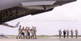 Dignified transfer officer orders “Present, Arms” (slow movement salute)
