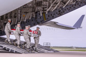 Air Force carry team carries transfer case of Staff Sgt. Richard A. Dickson to the mortuary transfer vehicle