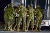 Marine Corps carry team places the transfer case of Sgt. Daniel M. Vasselian into the mortuary transfer vehicle.