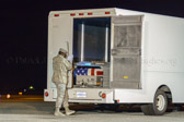 Transfer vehicle guide Airman Travis T. Beebe closes the doors to transfer vehicle.