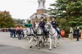 The silence of the procession is broken only by the rhythmic clip-clop of the seven handsome horses. Astride four of the horses, Soldiers sit ramrod straight. The horses, head erect, bodies taut and controlled, seem to imitate the solemn military bearing of the men and women who sit quietly in the saddles.