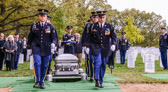 The CAO salutes the flag for three seconds before accepting it from the senior pallbearer. The senior pallbearer salutes the flag for three seconds after presenting it to the CAO. The CAO then moves by the most direct route to the next of kin who is to receive the flag.