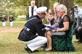 Jeri Heise is presented with the folded flag of her Father by BGen Kurt Stein