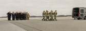 Dignified transfer officer orders “Present, Arms” (slow movement salute)<br /><br />Carry team moves transfer case into the mortuary transfer vehicle