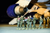 Marine carry team carries transfer case of "believed to be" Staff Sgt. Christopher K.A. Slutman to the mortuary transfer vehicle.