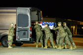 Carry team moves transfer case into the mortuary transfer vehicle<br /><br />Dignified transfer officer orders “Order, Arms” (slow movement salute)