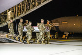 Carry team carries transfer case of Ensign Joshua Kaleb Watson  to the mortuary transfer vehicle
