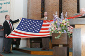 Dave Lalush, holding the folded American flag, whose only son Michael Vernon Lalush was killed in a UH-1N Huey helicopter crash in southern Iraq. He was assigned to Marine Light Attack Helicopter Squadron (HMLA)-169, Marine Aircraft Group-39, Marine Corps Air Station, Camp Pendleton, California. Died on March 30, 2003.