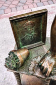 A small flower pot, on its side, symbolizes her world devastated.