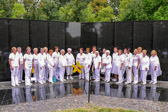Gold Star Mother President Molly Morel, behind wreath, all pause for a photograph before heading to Arlington National Cemetery