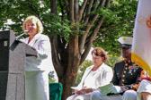 Norma Luther introducing the guest speaker 16th Sergeant Major of the Marine Corps Carlton W. Kent.