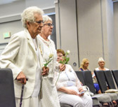 Terry Davis and Georgie Carter-Krell, Past National Presidents place white roses in remembrance of deceased Gold Star Mothers.