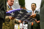 Gold Star Mother Becky Christmas explains the thirteen folds of Our Flag while the Gold Star Dads slowly do each fold.
