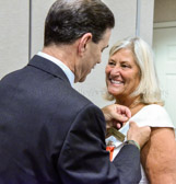 Bill Pollard, husband of incoming President Sue Pollard pinning his beautiful bride.
