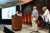 Sue Reich, President Quilts of Valor reads remarks before presenting Terry Geiling, Gold Star Mother Manor CEO with his Quilt of Honor.