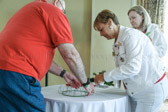 Wayne Hanson helping the Moms (Patti Elliott) make up a wreath from cuttings