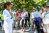 Gold Star Mother Joyce Paulsen, Banner Guard  speaks at the statue of the Three Soldiers.