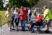 Vietnam Veterans escort Gold Star Mothers National President Sarah Taylor to the apex of the Vietnam Veterans Memorial to place a wreath.