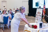 Gold Star Mom Annette Kirk places a bouguet of Roses