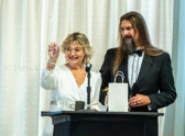 AMVETS Chaplain Jeremiah Botkin presents National President Patti Elliott with a glass etching of her son Lucas