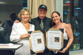 Tim Maggart presents framed copies of the lyrics to his song “Heart of a Gold Star” to National President Patti Elliott and Gold Star Mom Nichole Jackson Chilton who designed the cover.