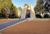 Australian Vietnam Forces National Memorial, Dedicated October 3, 1992 Camberra.<br />The image etched onto the wall of the memorial is based on the photograph taken by Sgt. Mike Coleridge on August 26, 1967, near Lang Phuoc Hai, Phuoc Tuy Province.  It shows soldiers from 7RAR being airlifted to Nui Dat after the completion of Operation Ulmarrah.   Quotations on the wall reflect a unique vocabulary developed during the Vietnam War.  Contained within the circle suspended above are the names of those Australians who died in the Vietnam War 1962-1973