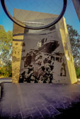 The stele are tapered and inclined to the centre, symbolizing commemoration and contemplation. Suspended from the stele and forming the centerpiece of the memorial is a granite ring or halo symbolizing the spirits of the dead being lifted from the Earth.